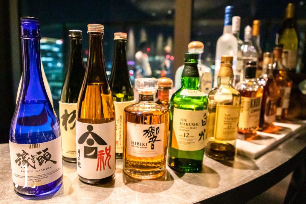 Selection of premium Japanese whisky and sake bottles at a luxury bar in Tokyo