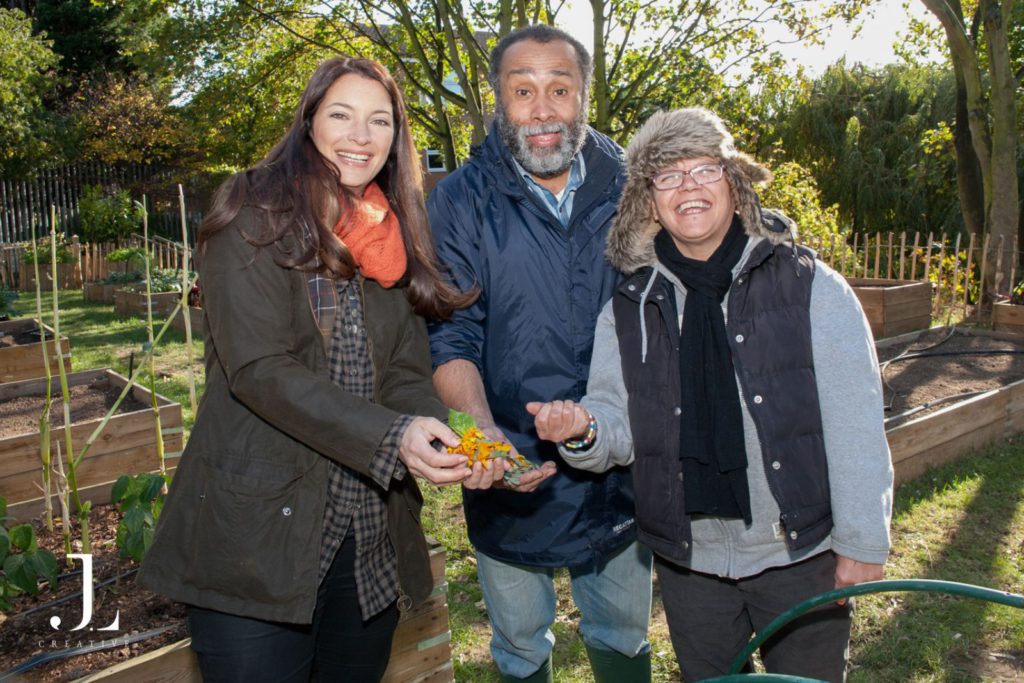 A group of volunteers and participants connecting outdoors during a Mind community project.
