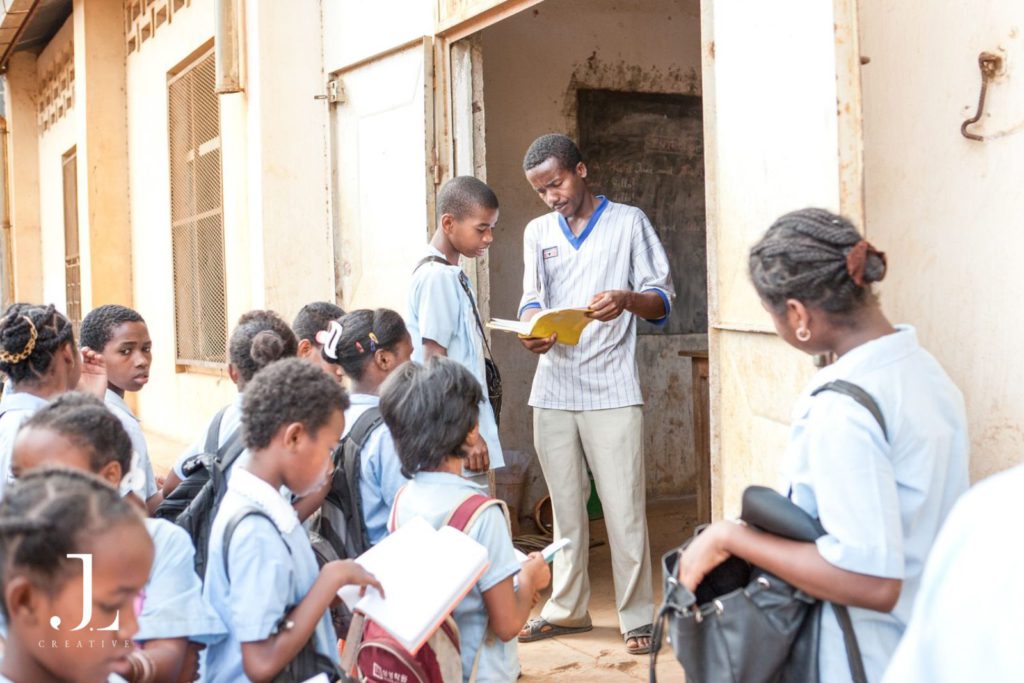 teacher checking his student's notebook