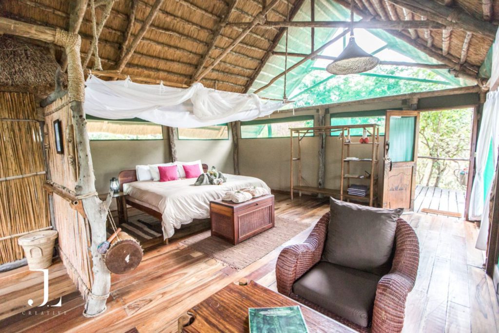 Safari lodge bedroom with natural textures and soft lighting in Malawi