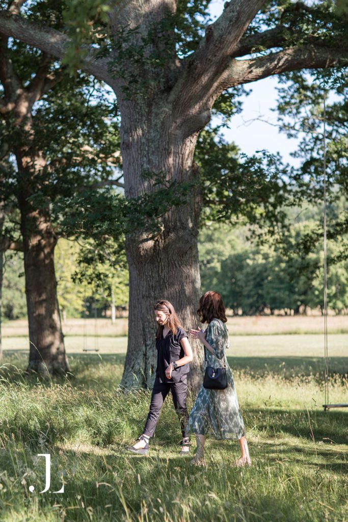 Travel partners networking in the shade of old trees during a Belmond event