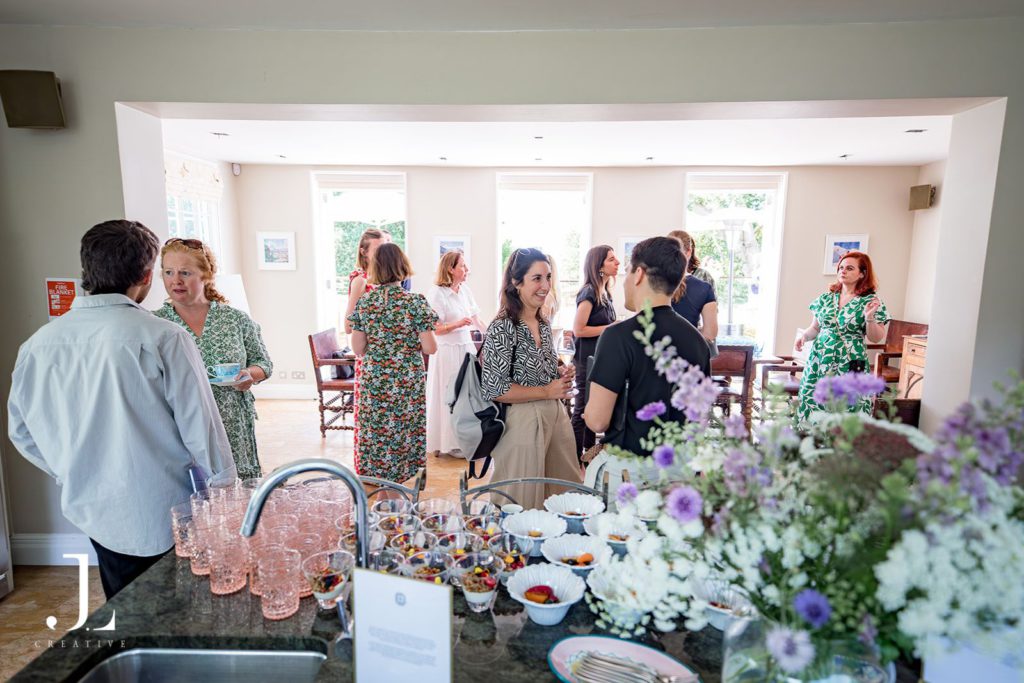 Wide view of guests networking in an elegant room at the Belmond Secret Retreat