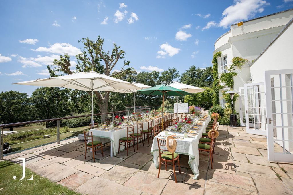elegant outdoor lunch setup under trees for a luxury event at Knepp Estate