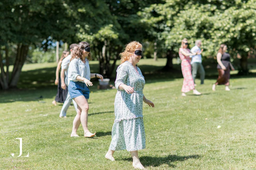 Guests participating in a nature-inspired wellness session in a shaded woodland clearing