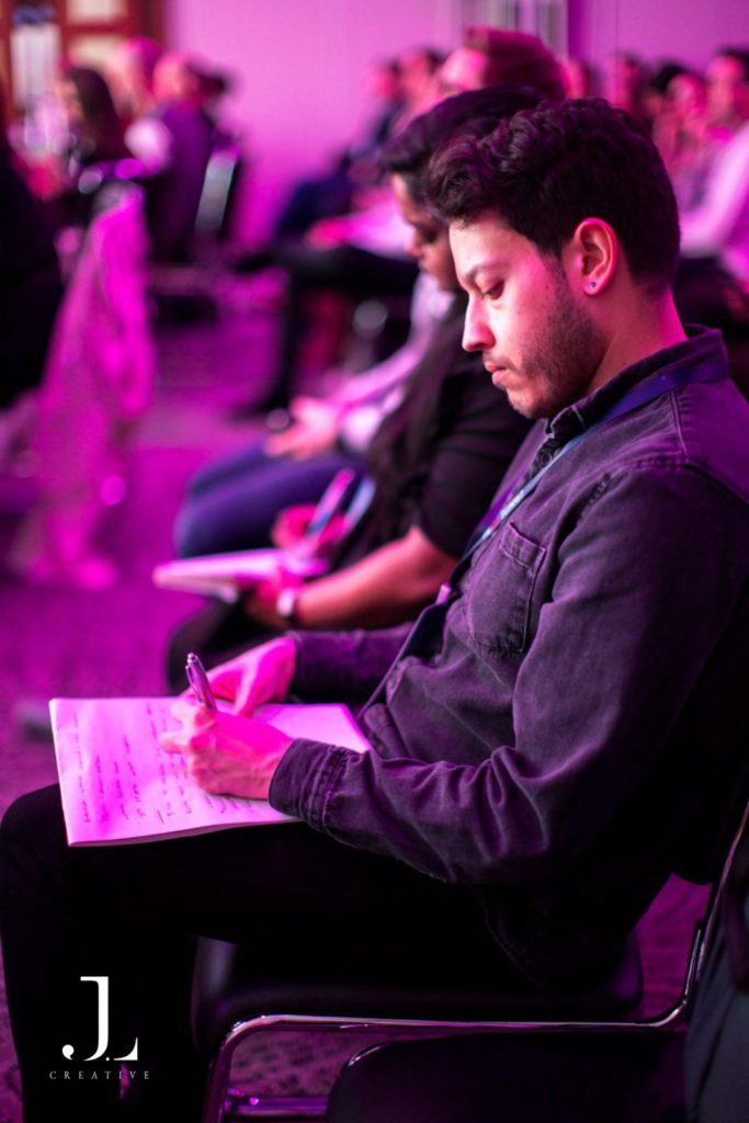 Delegates taking notes at tech conference