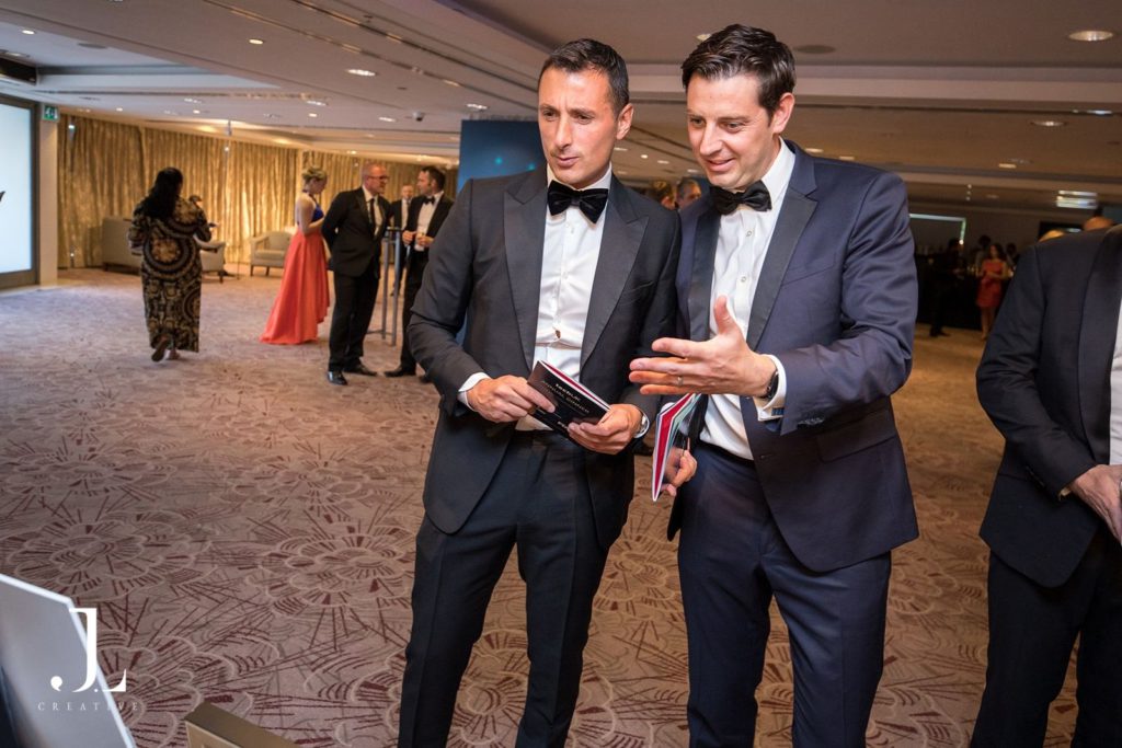 Guests in front of a TechUK branded backdrop at a London gala