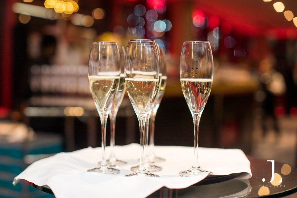Close-up of champagne being poured into flutes at a corporate reception
