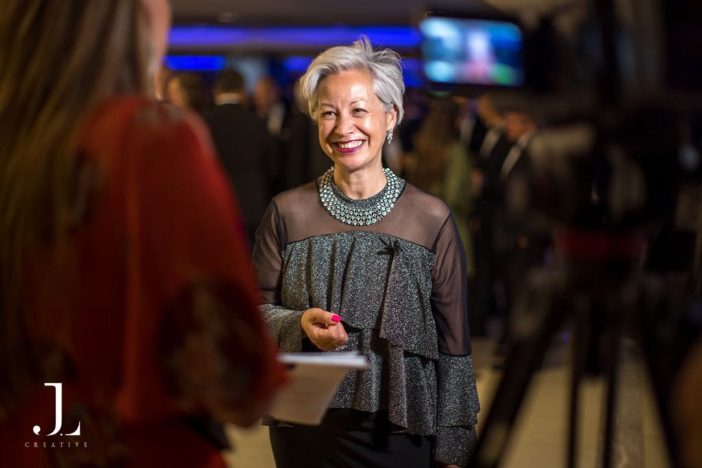 business evePortrait of a smiling female speaker at a formal London eventnt photography London