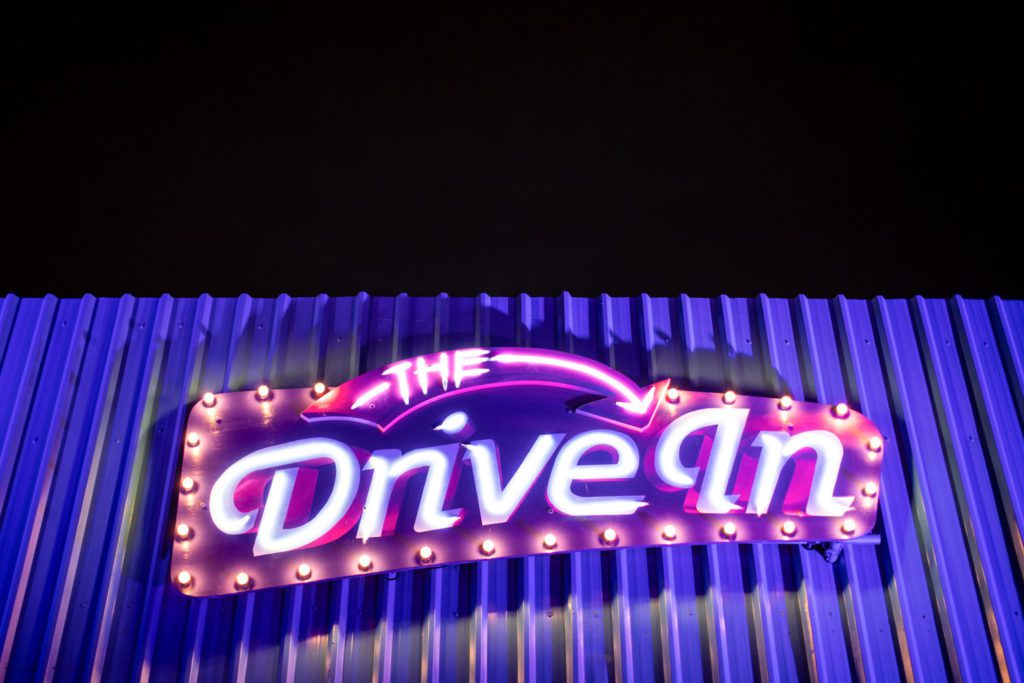 Retro neon sign for "The Drive In" at night, captured by a London event photographer.