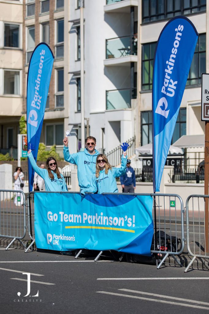 Volunteers cheering with banners at marathon charity event London