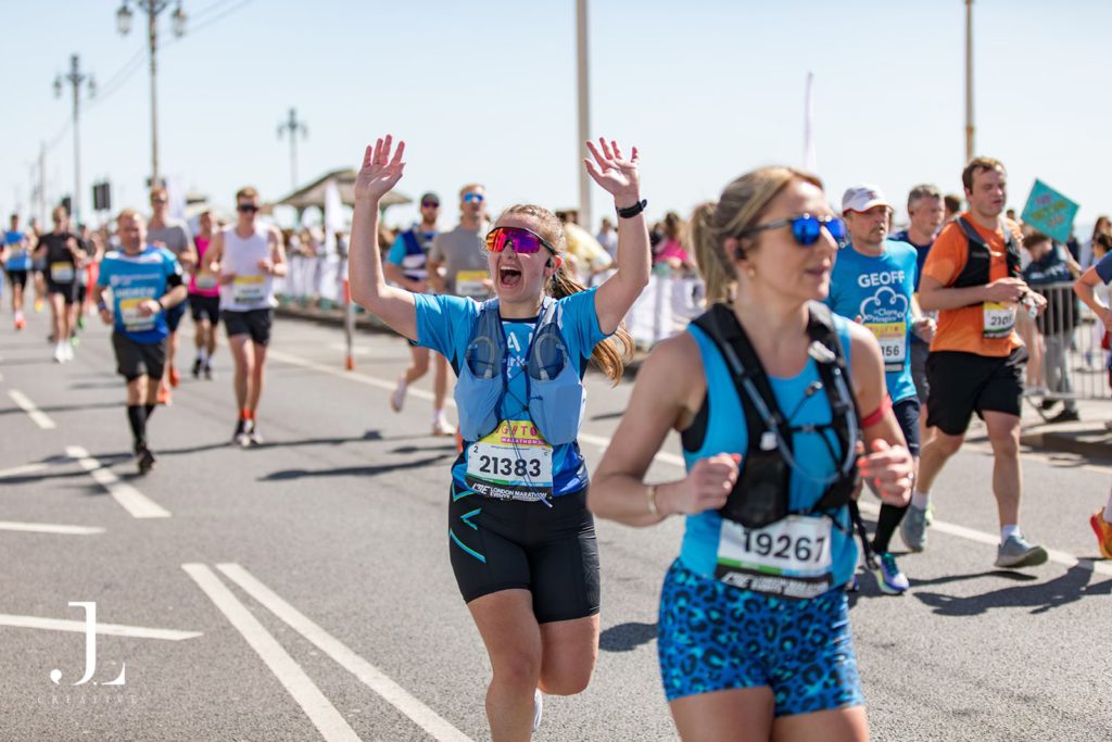 Runner celebrating with raised arms at London Landmarks Half Marathon