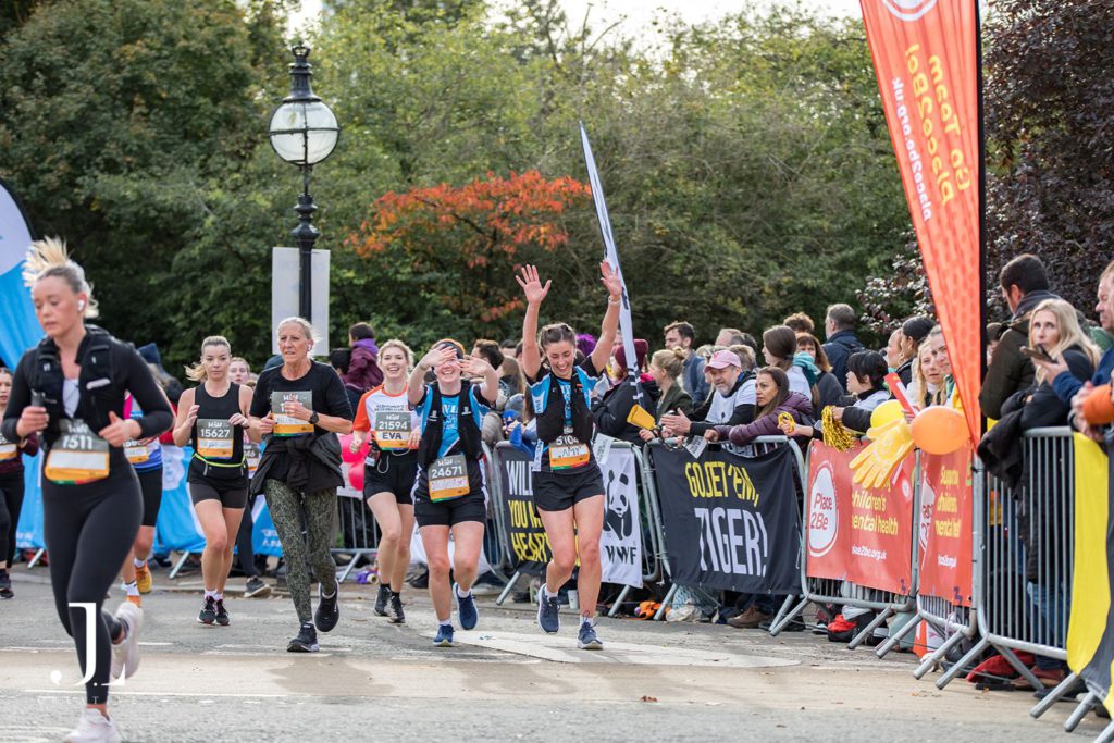 Runner celebrating with raised arms at London Landmarks Half Marathon