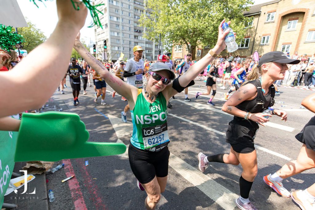 Runner celebrating with raised arms at London Landmarks Half Marathon
