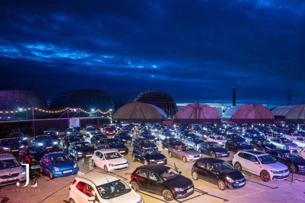 Outdoor drive-in cinema at night with rows of cars, event photography London.