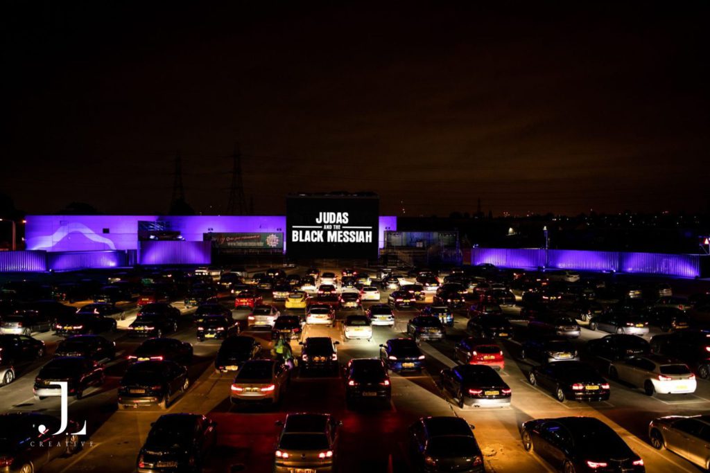 Outdoor drive-in cinema at night with rows of cars, event photography London.