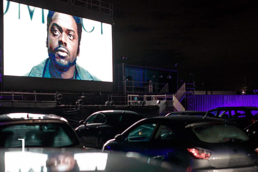Outdoor drive-in cinema at night with rows of cars, event photography London.