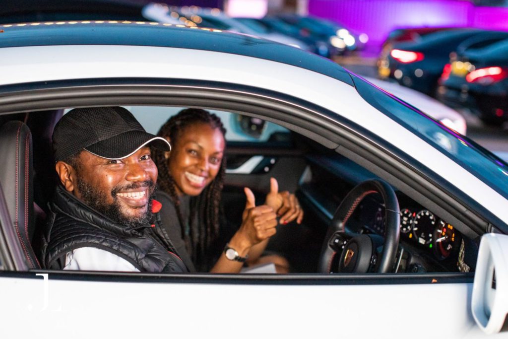 Guests posing in their vehicle at an outdoor London event, event photography London.