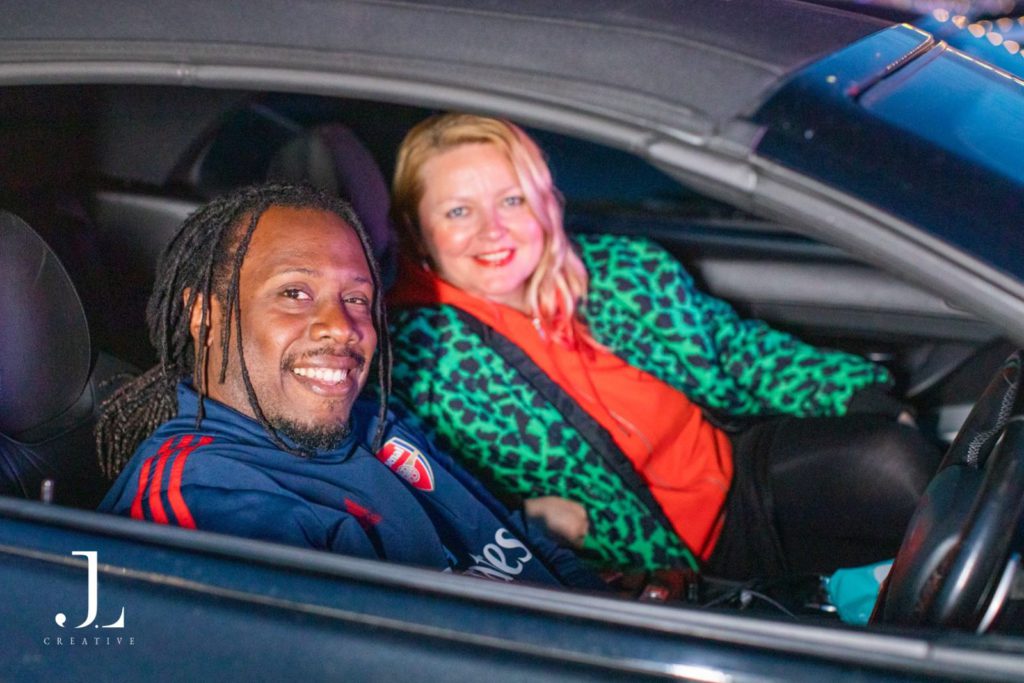 Guests posing in their vehicle at an outdoor London event, event photography London.
