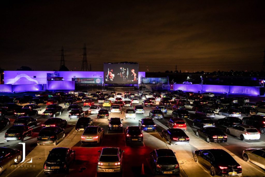 Outdoor drive-in cinema at night with rows of cars, event photography London.