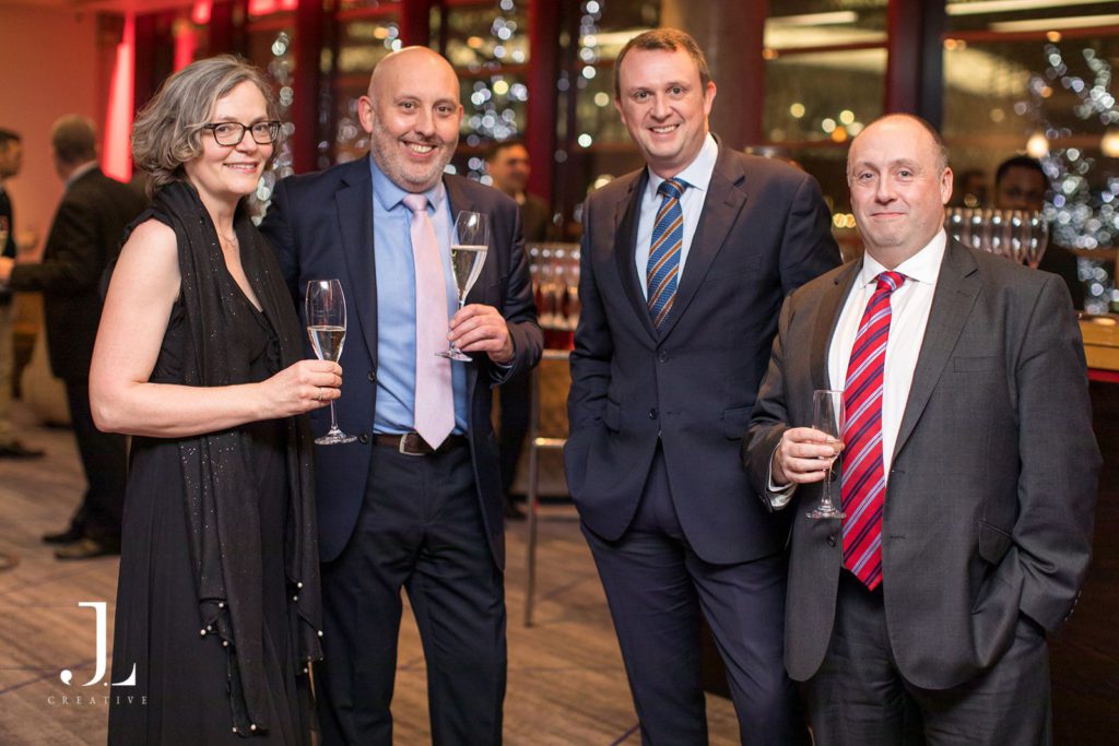 Exclusive event photography of guests in formal attire enjoying a high-end drinks reception in London.