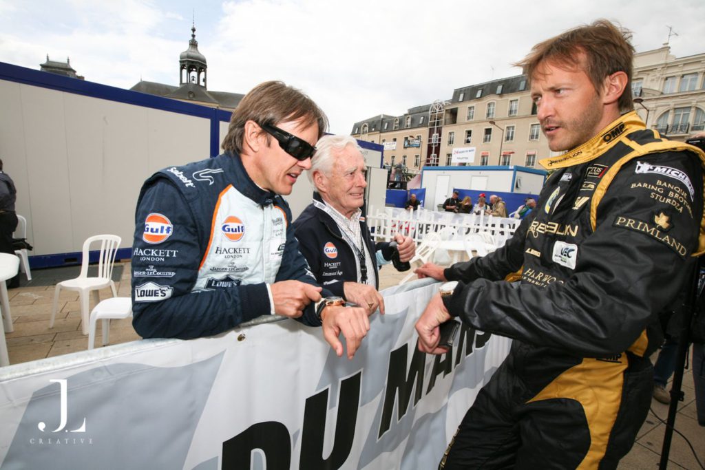 International event photographer documenting drivers in professional racing gear at a world-class motorsport event.
