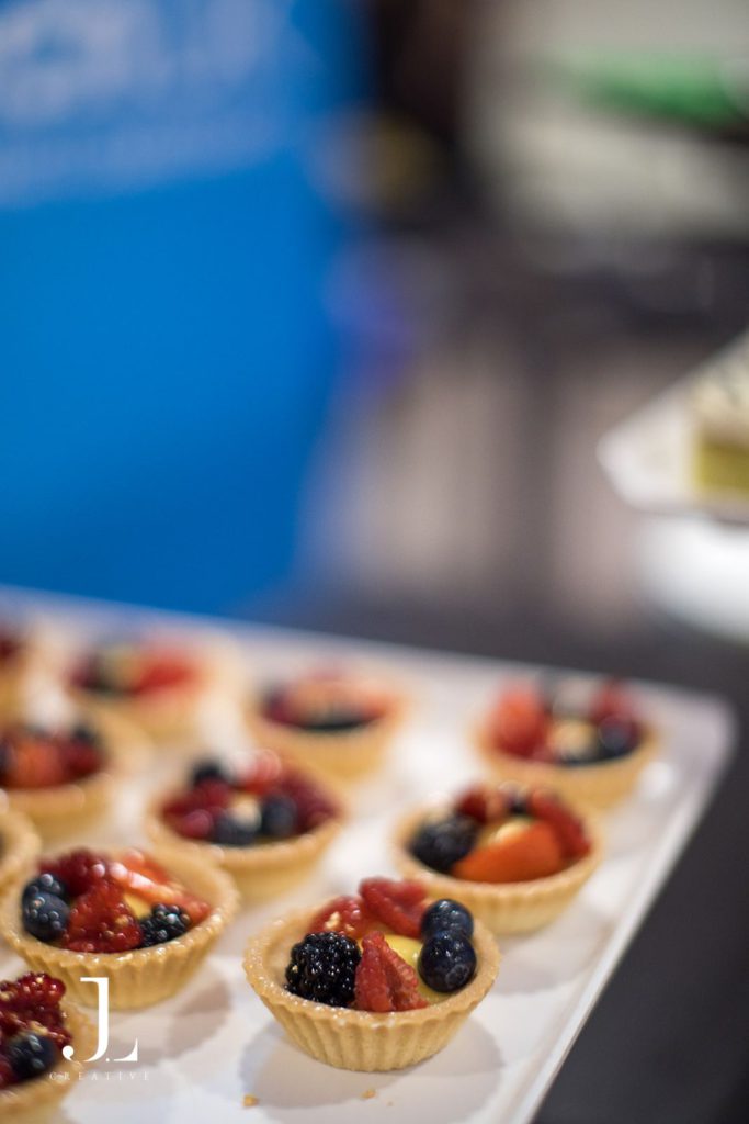 Close-up of gourmet fruit tarts prepared for an exclusive event by high-end hospitality catering.