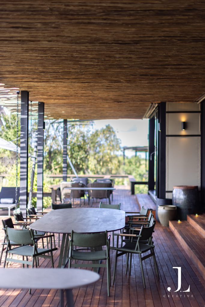 Covered outdoor dining deck with sleek table seating, shot for luxury hospitality photography in the Delta.