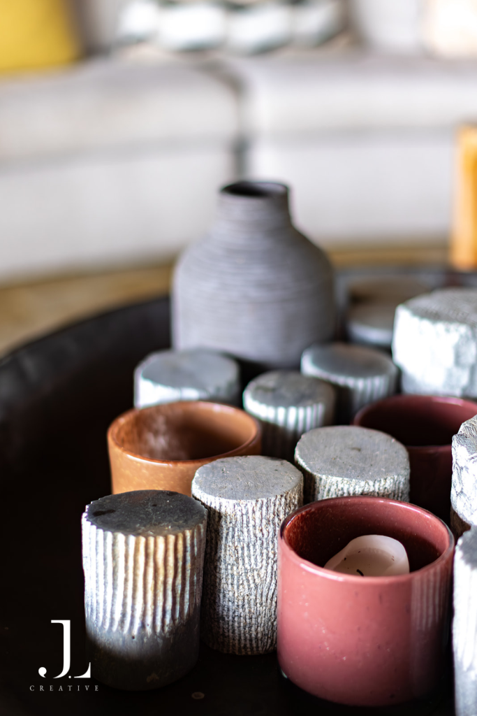 Close-up detail of ceramic decor objects and candleholders, capturing luxury safari lodge photography details.