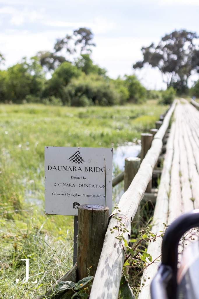 Close-up of Daunara Bridge sign post by the wetlands, captured for luxury hotel PR photography in Botswana.