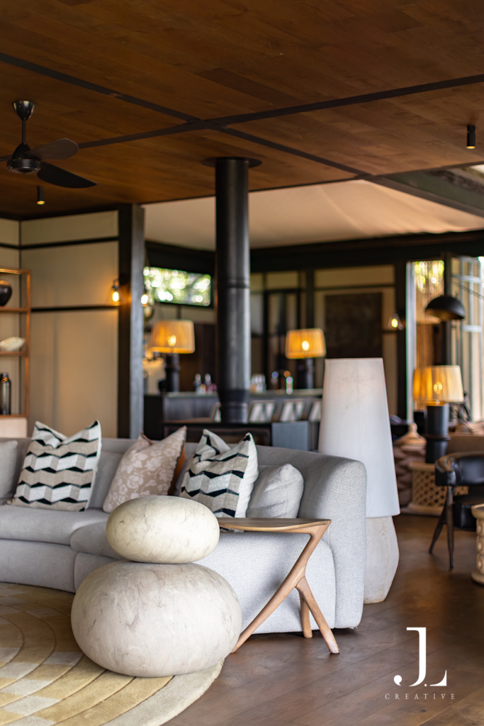 Plush curved sofa and contemporary lounge interior, captured for luxury hotel PR photography in Okavango Delta.