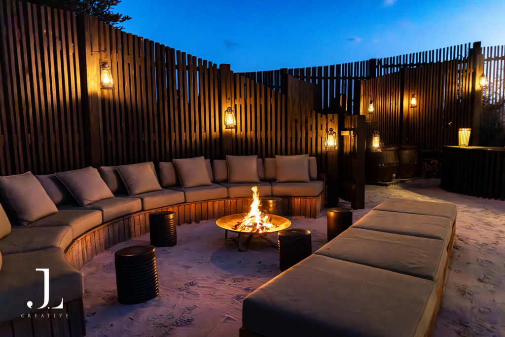 Open-air boma fire pit with plush seating under night sky, featuring safari camp photography Botswana.