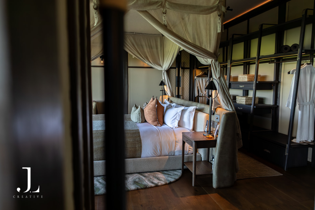 Luxury tented suite bedroom with canopy bed, showcasing interior luxury safari lodge photography at Daunara.