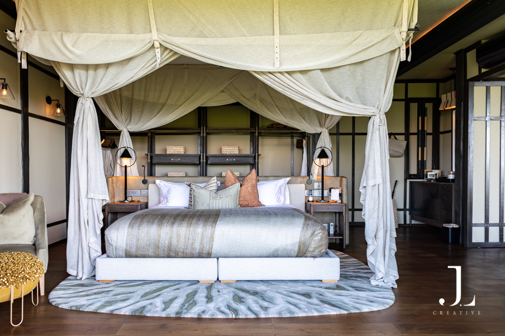 Luxury safari suite bedroom with draped canopy bed, showcasing luxury safari lodge photography at Daunara.